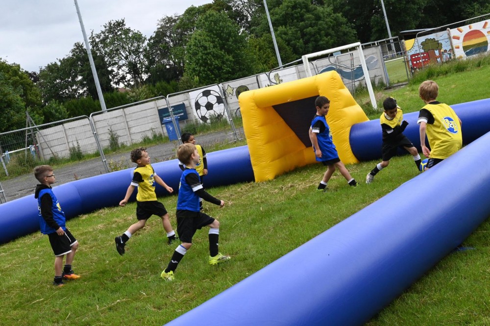 kids playing on inflatable pitch