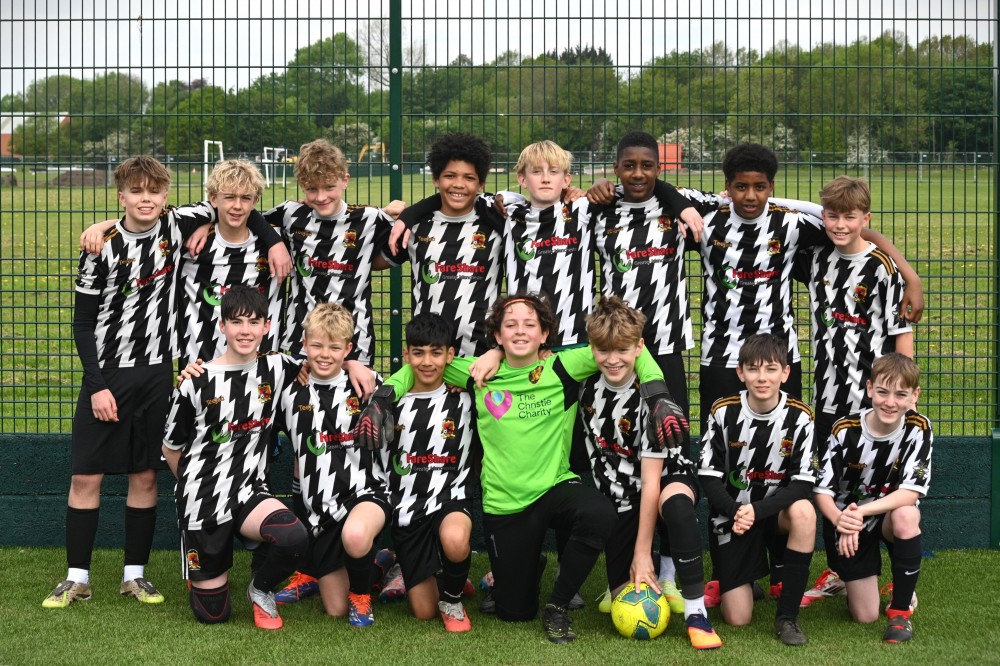 Group of juniors in black and white gather for team photo