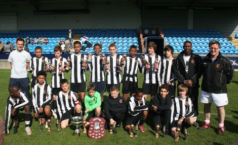 U13s with league and cup winners trophies