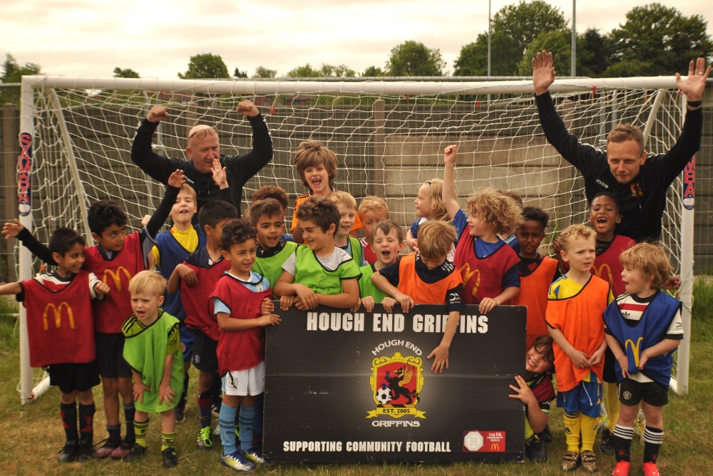 Team photo of junior football players in front of a net