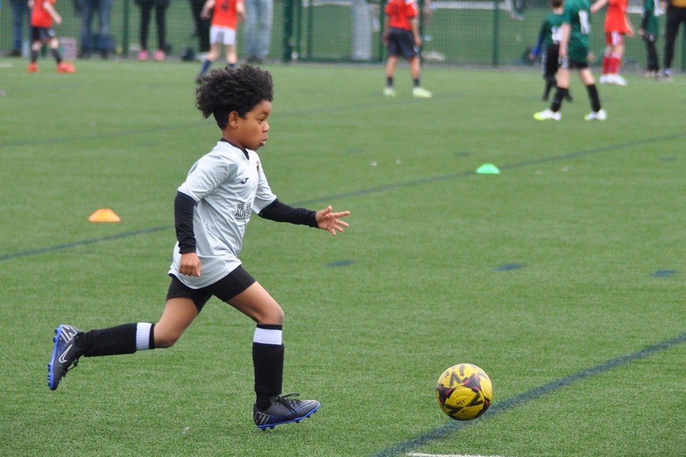 Boy running to kick a ball